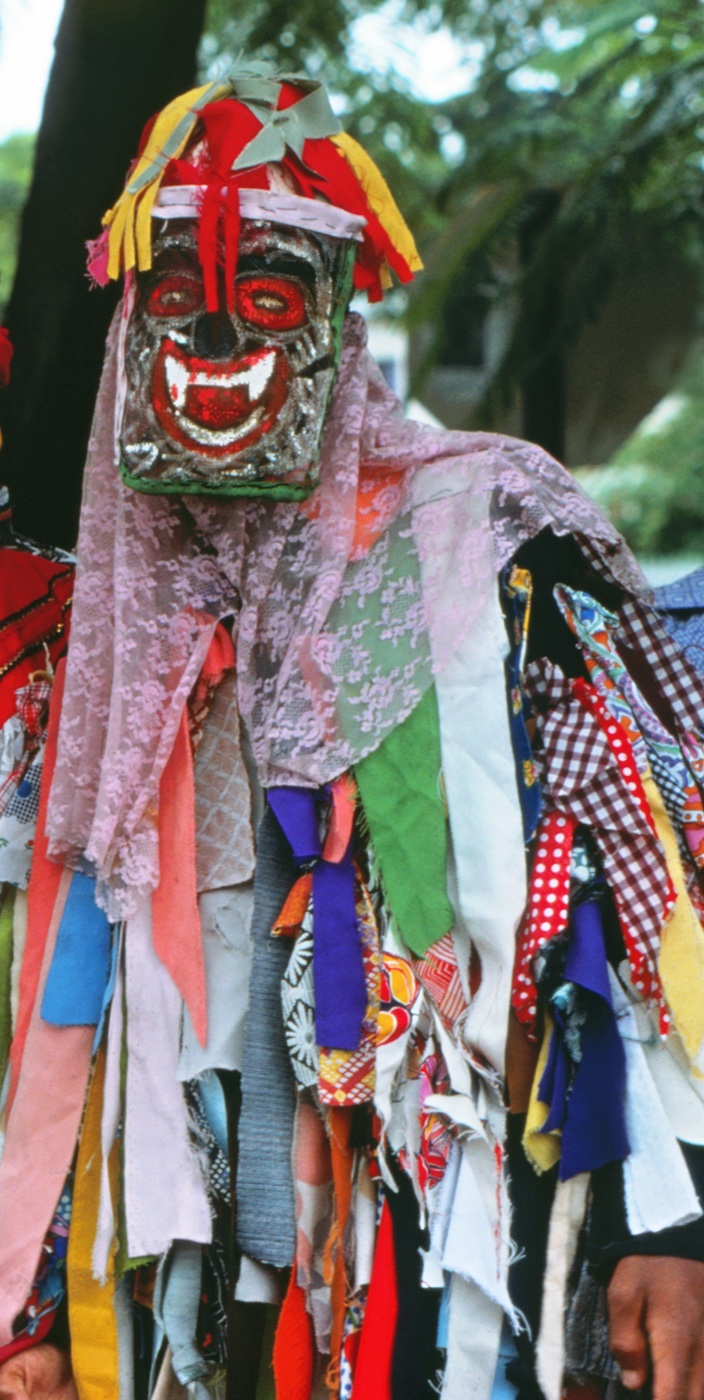 Pitchy Patchy, one of the John Canoe (Jonkonnu) characters, in Jamaica, December 1975. Photo: WikiPedant, CC BY-SA 4.0, via Wikimedia Commons.